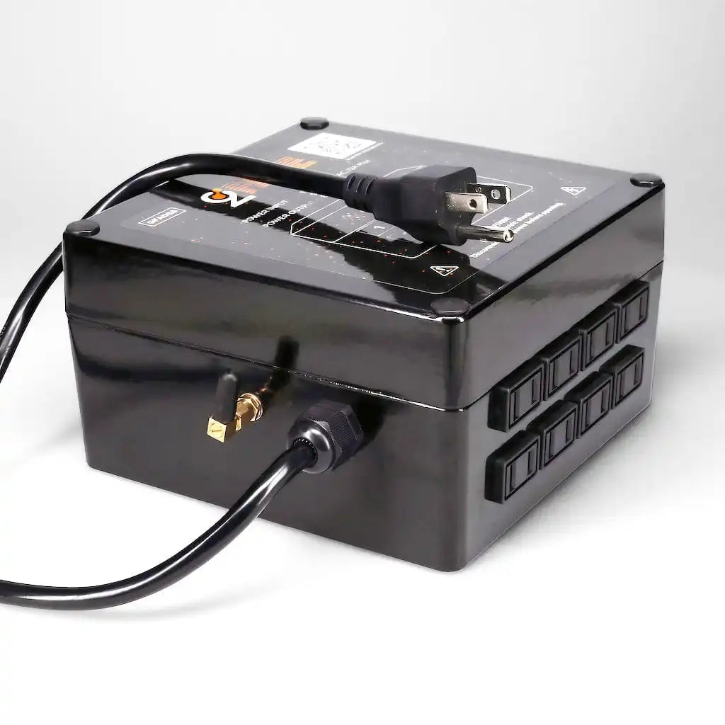 A black electrical power distribution box with multiple outlets and a power cord.