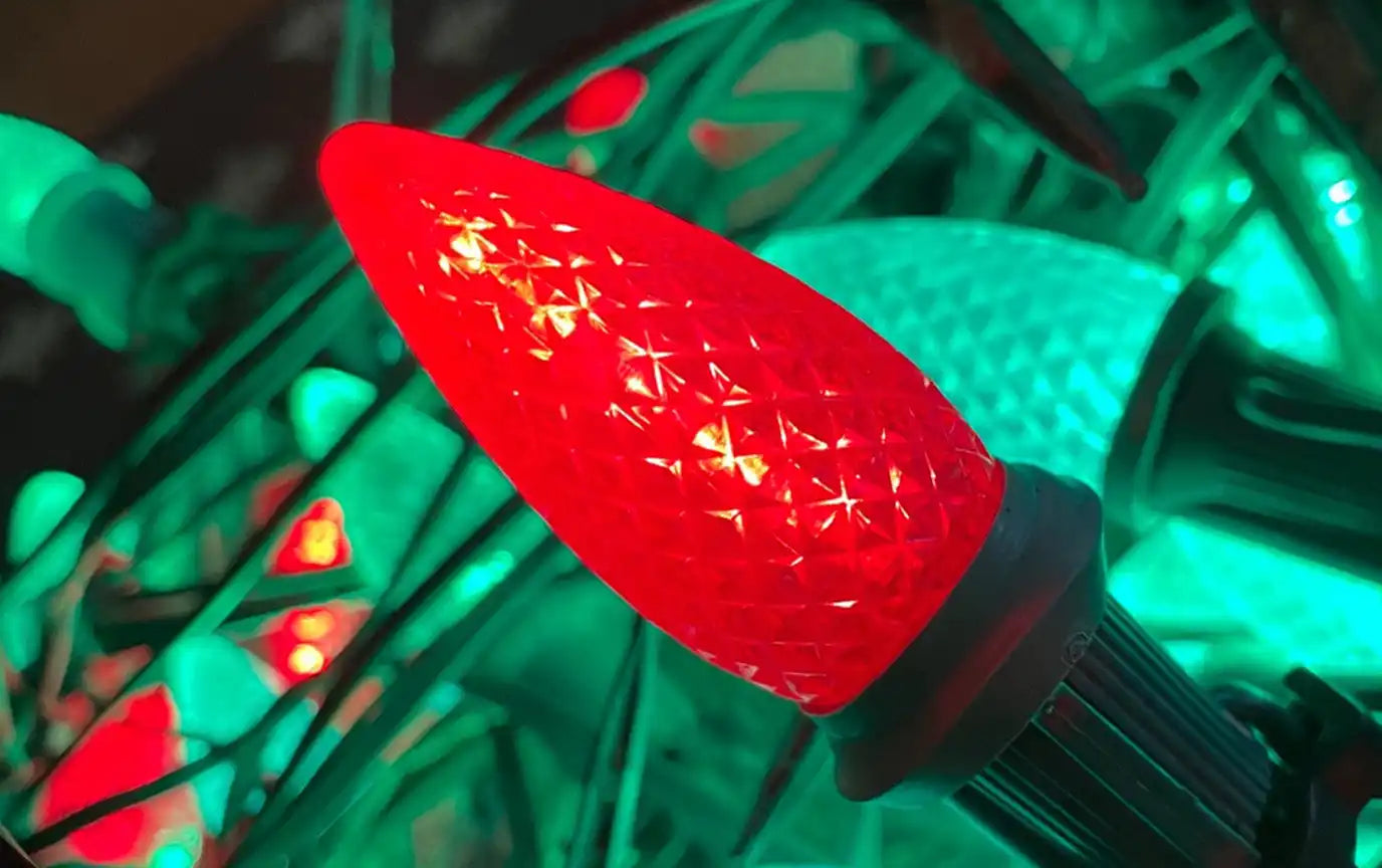 A bright red, textured LED Christmas light bulb.